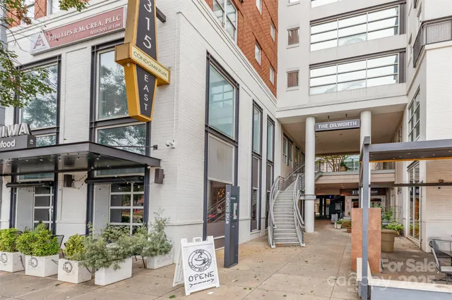 a view of a building with a window and potted plants