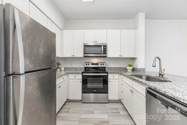 a kitchen with a refrigerator stove and sink