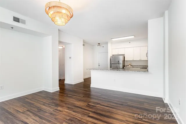 a view of kitchen with microwave and cabinets