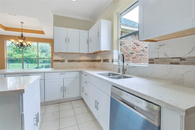 a kitchen with a sink cabinets and window