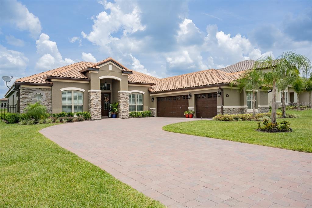 a front view of a house with a yard and garage