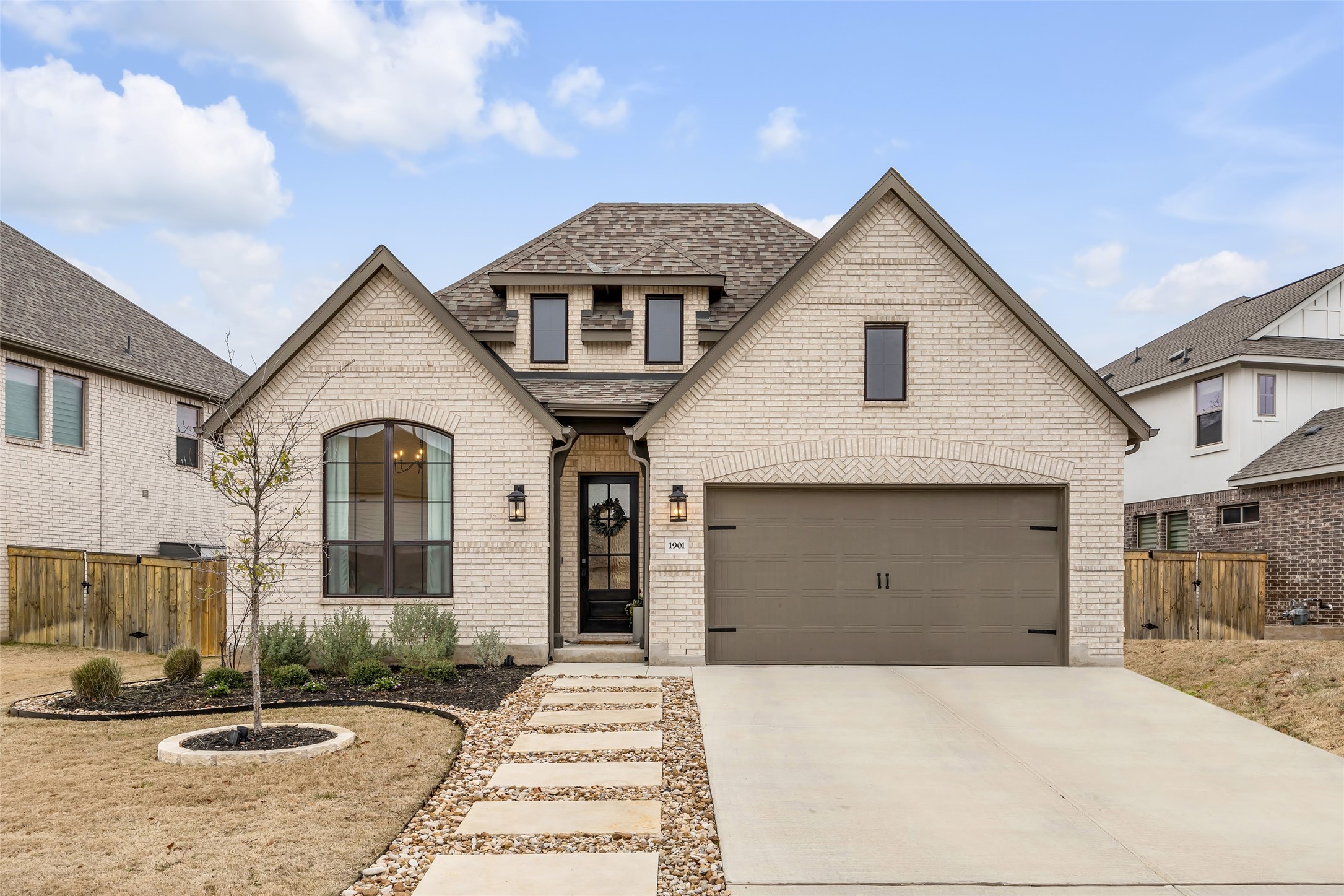 1901 Sir Nathaniel Lane Leander, TX 78641 - Photo 1 of 40 View of front of house featuring brick siding, roof with shingles, driveway, and a garage