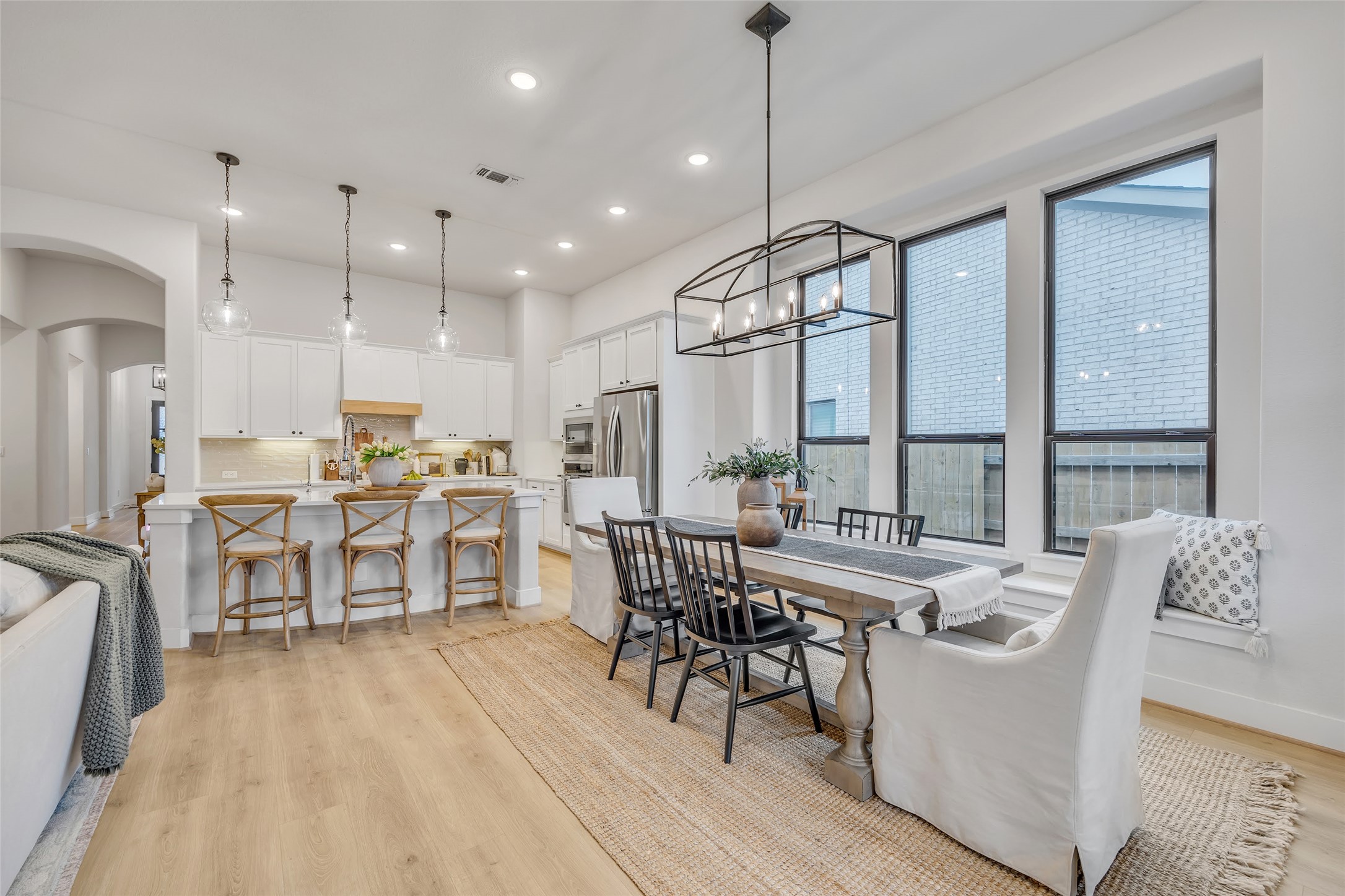 1901 Sir Nathaniel Lane Leander, TX 78641 - Photo 11 of 40 Dining room with light wood-style flooring, arched walkways, and suspended lighting