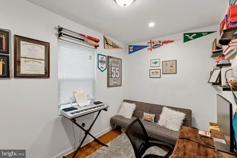 a living room with furniture and painting on the wall