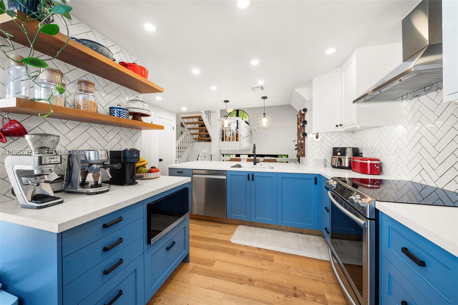 3237 Mary Street, Unit 6 Miami, FL 33133 - Photo 19 of 54 a kitchen with stainless steel appliances kitchen island granite countertop a sink and cabinets