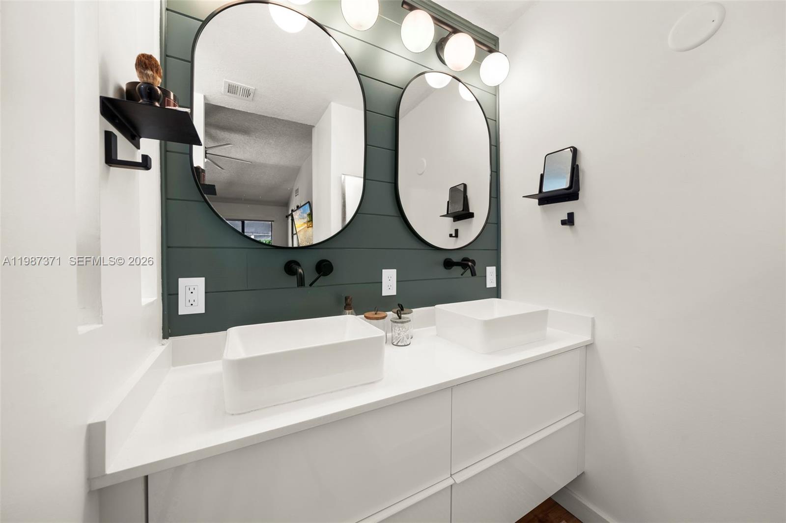 3237 Mary Street, Unit 6 Miami, FL 33133 - Photo 35 of 54 a bathroom with a sink and a mirror