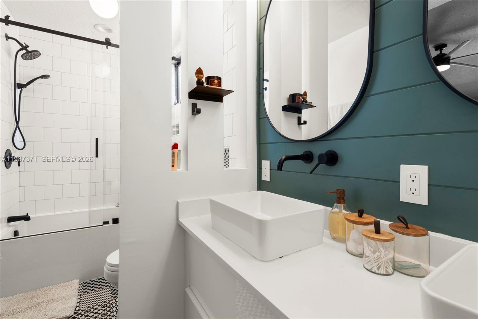 3237 Mary Street, Unit 6 Miami, FL 33133 - Photo 38 of 54 a bathroom with a sink mirror and toilet