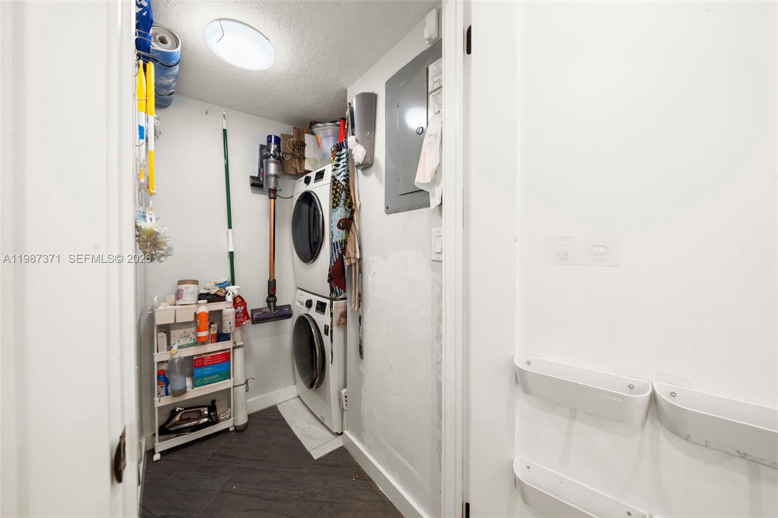3237 Mary Street, Unit 6 Miami, FL 33133 - Photo 40 of 54 a view of walk in closet with clothes and shoes