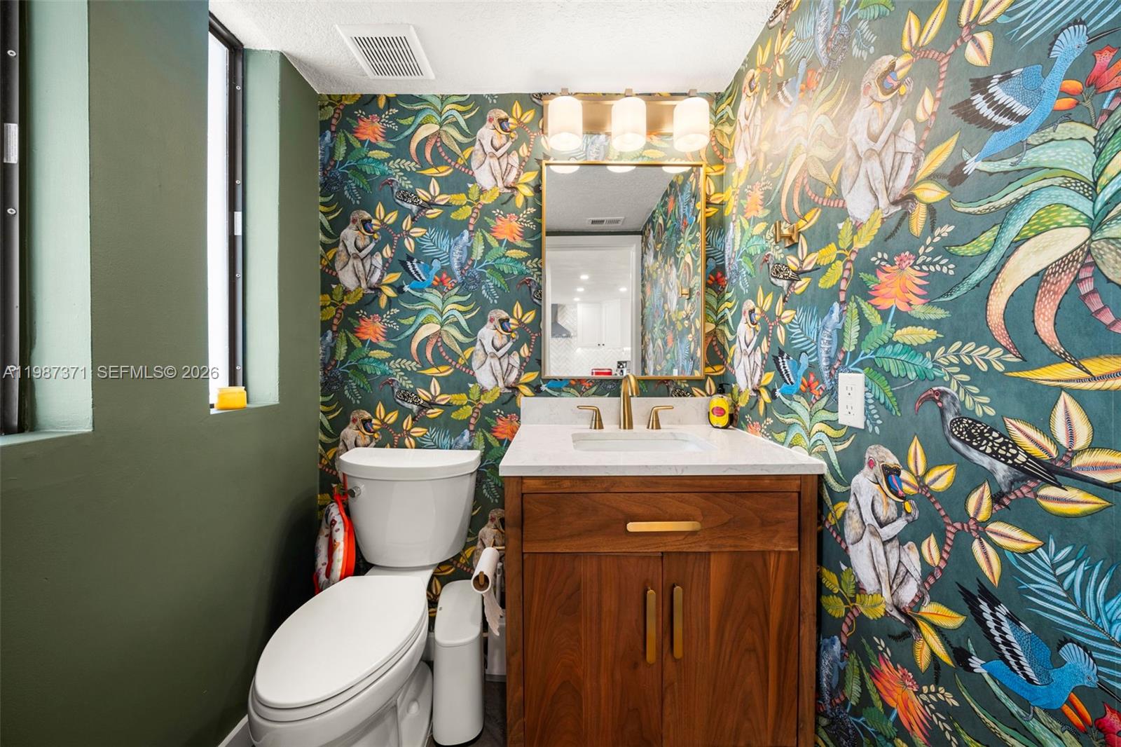 3237 Mary Street, Unit 6 Miami, FL 33133 - Photo 4 of 54 a bathroom with a granite countertop toilet and a sink