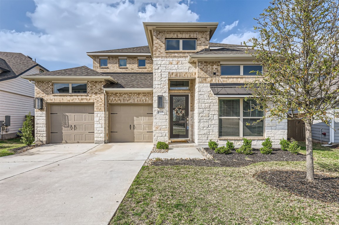a front view of a house with garden