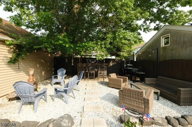 a view of a chairs and table in backyard