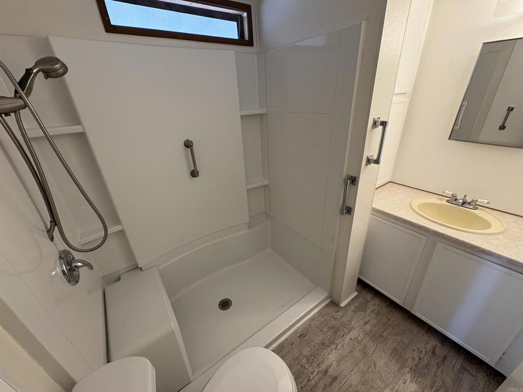 41 Hummingbird Lane Oceanside, CA 92057 - Photo 13 of 13 a bathroom with a granite countertop sink mirror vanity and toilet