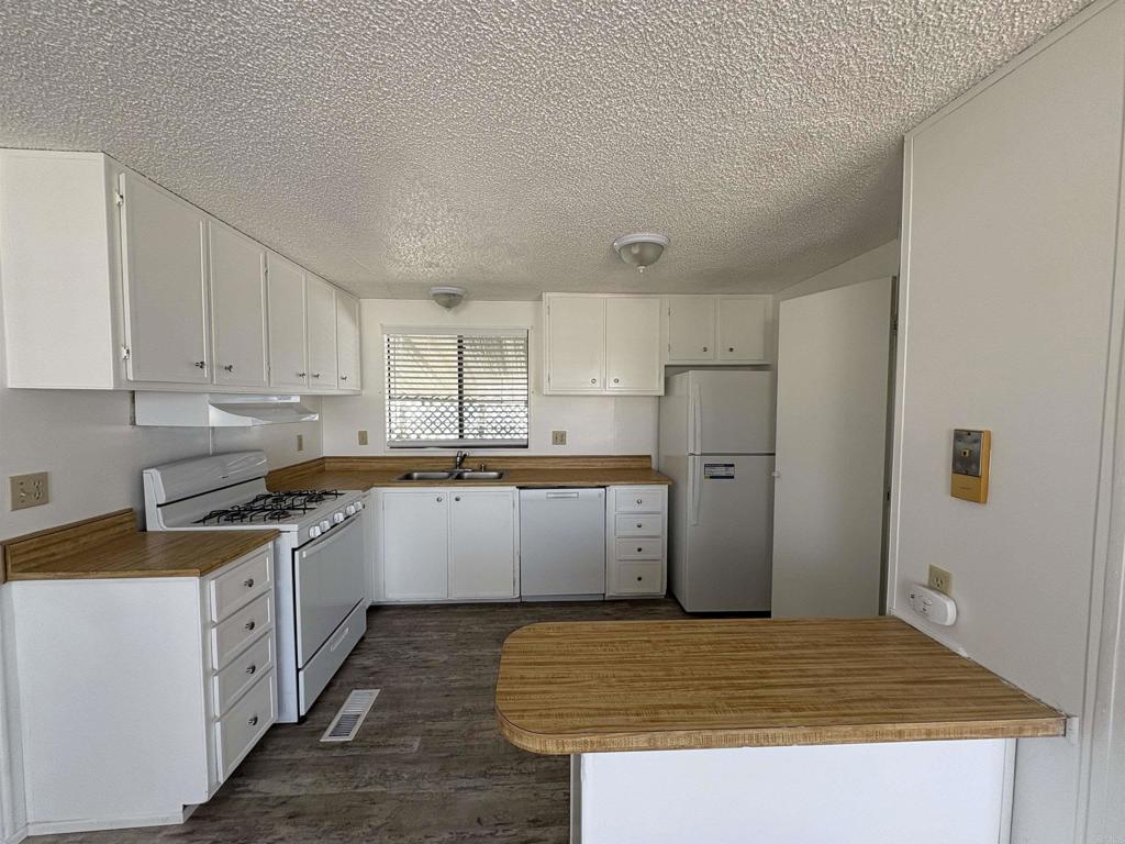 41 Hummingbird Lane Oceanside, CA 92057 - Photo 7 of 13 a kitchen with stainless steel appliances granite countertop a sink stove and refrigerator