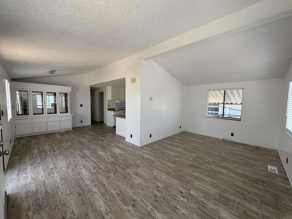 41 Hummingbird Lane Oceanside, CA 92057 - Photo 8 of 13 a view of a big room with wooden floor and windows