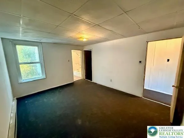 a view of an empty room and a window