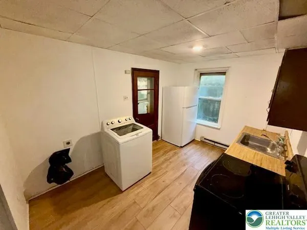 a living room with a bed furniture and a window