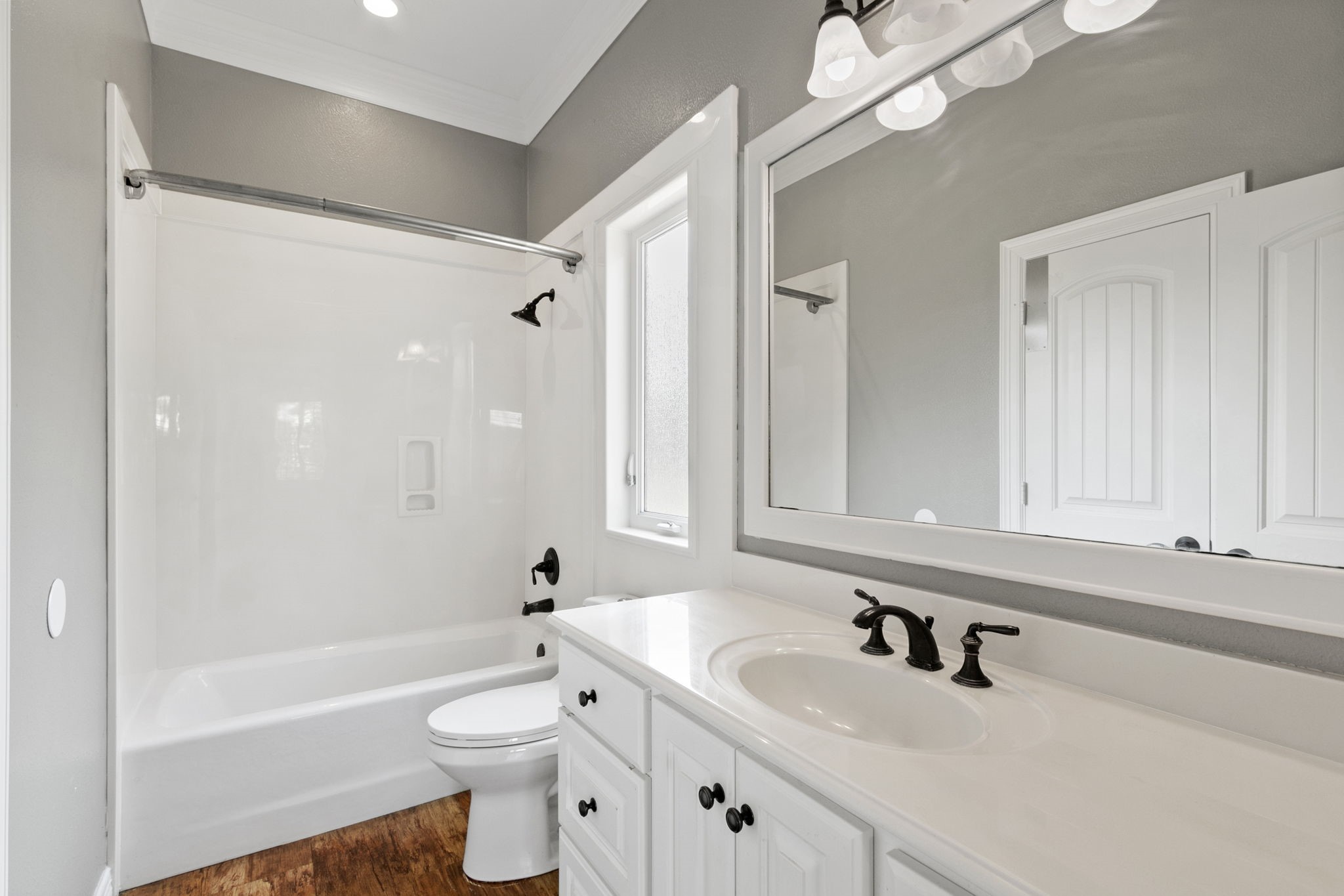 17018 Grant Road Cypress, TX 77429 - Photo 21 of 50 a bathroom with a sink a toilet a mirror and shower