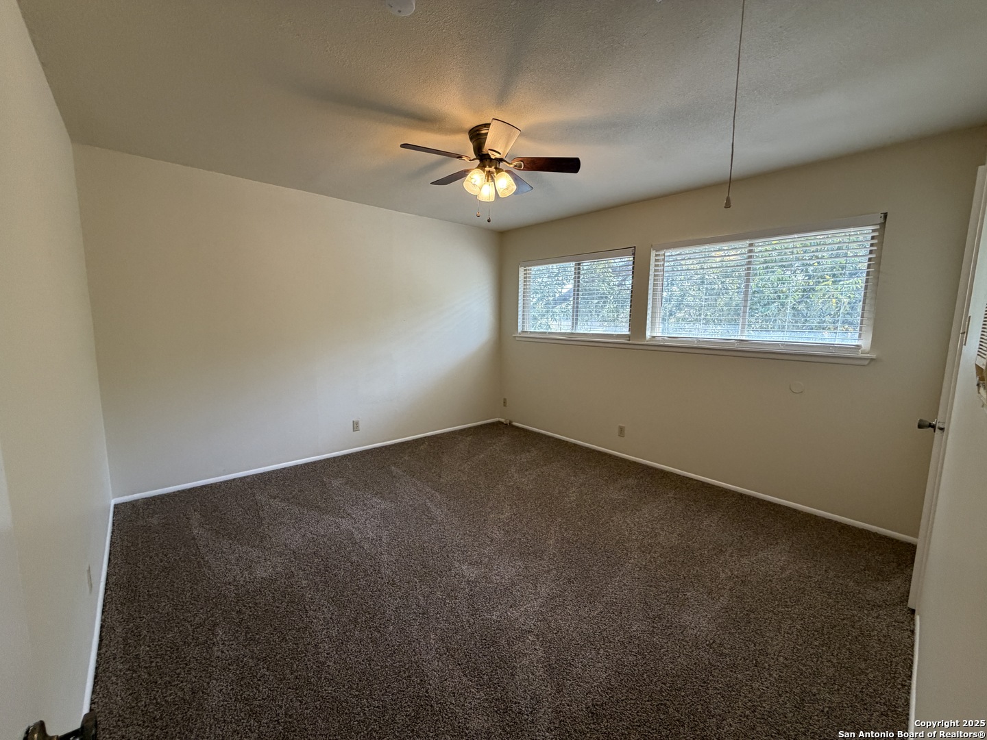1236 East Live Oak Road Schertz, TX 78154 - Photo 12 of 20 an empty room with a window and a fan