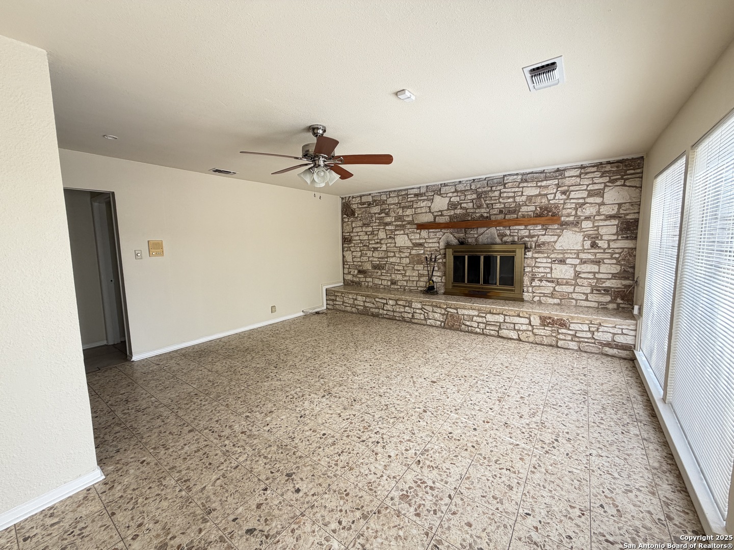 1236 East Live Oak Road Schertz, TX 78154 - Photo 17 of 20 an empty room with fireplace and windows