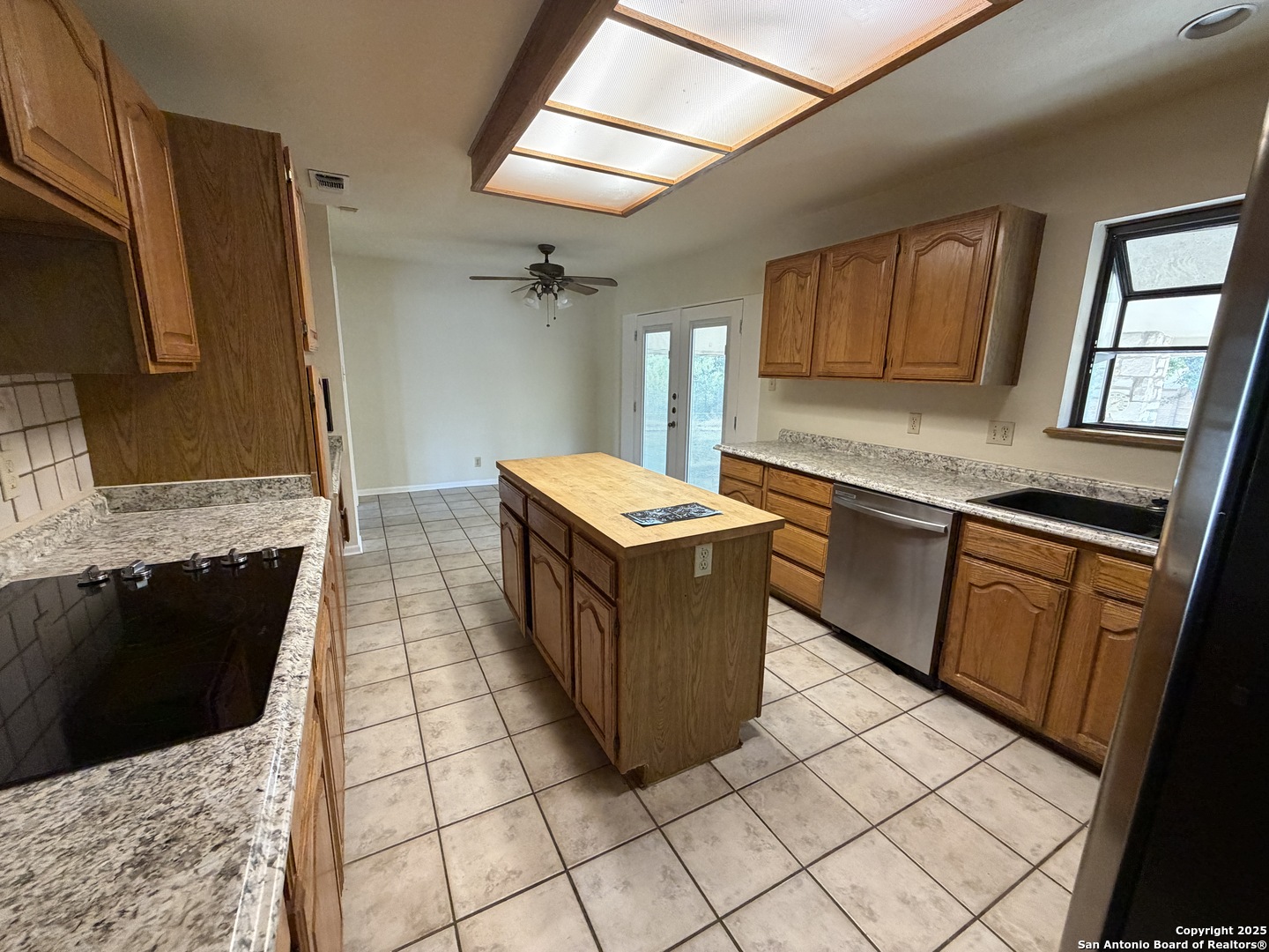 1236 East Live Oak Road Schertz, TX 78154 - Photo 3 of 20 a kitchen with stainless steel appliances granite countertop a stove a sink and a microwave