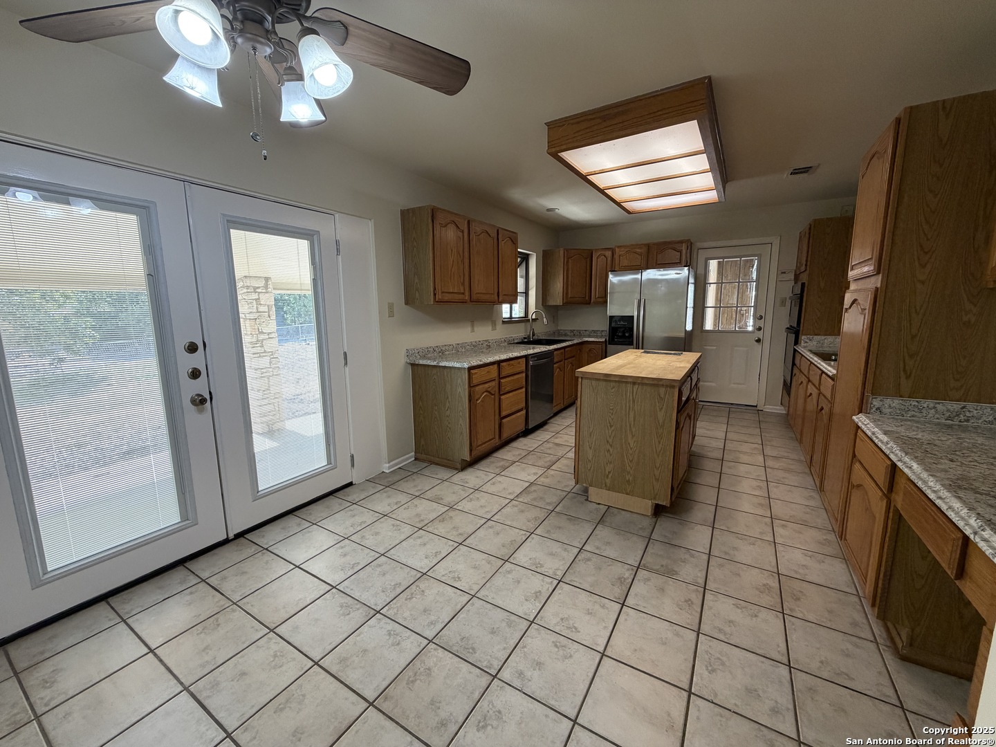1236 East Live Oak Road Schertz, TX 78154 - Photo 5 of 20 a kitchen with stainless steel appliances granite countertop a refrigerator and a stove top oven