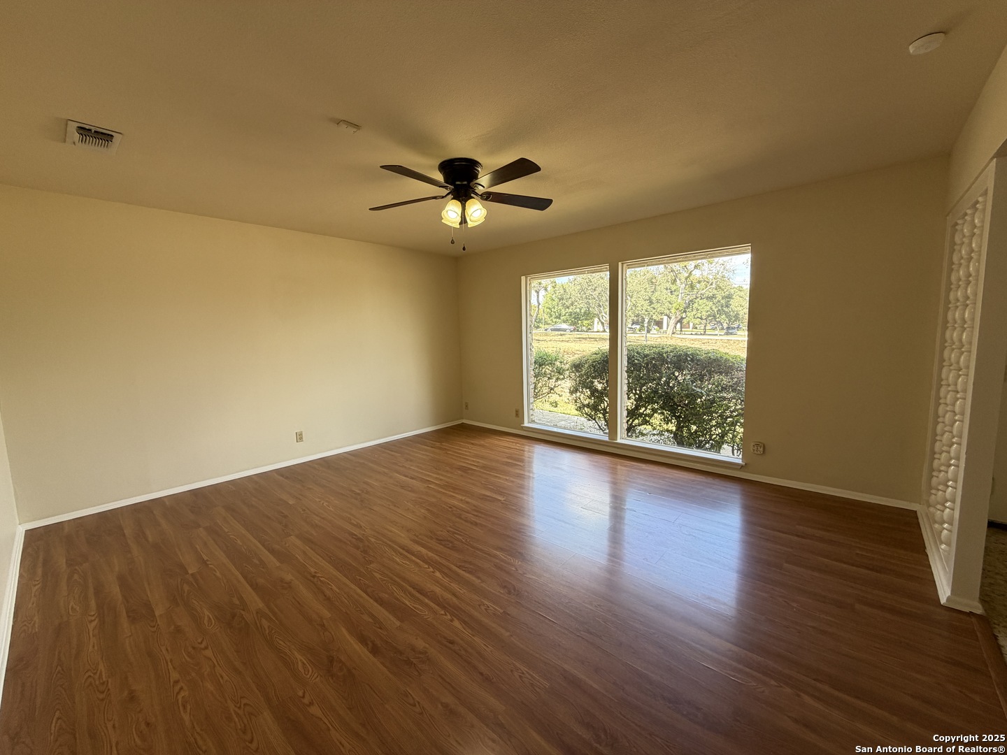 1236 East Live Oak Road Schertz, TX 78154 - Photo 7 of 20 a view of room with wooden floor and fan