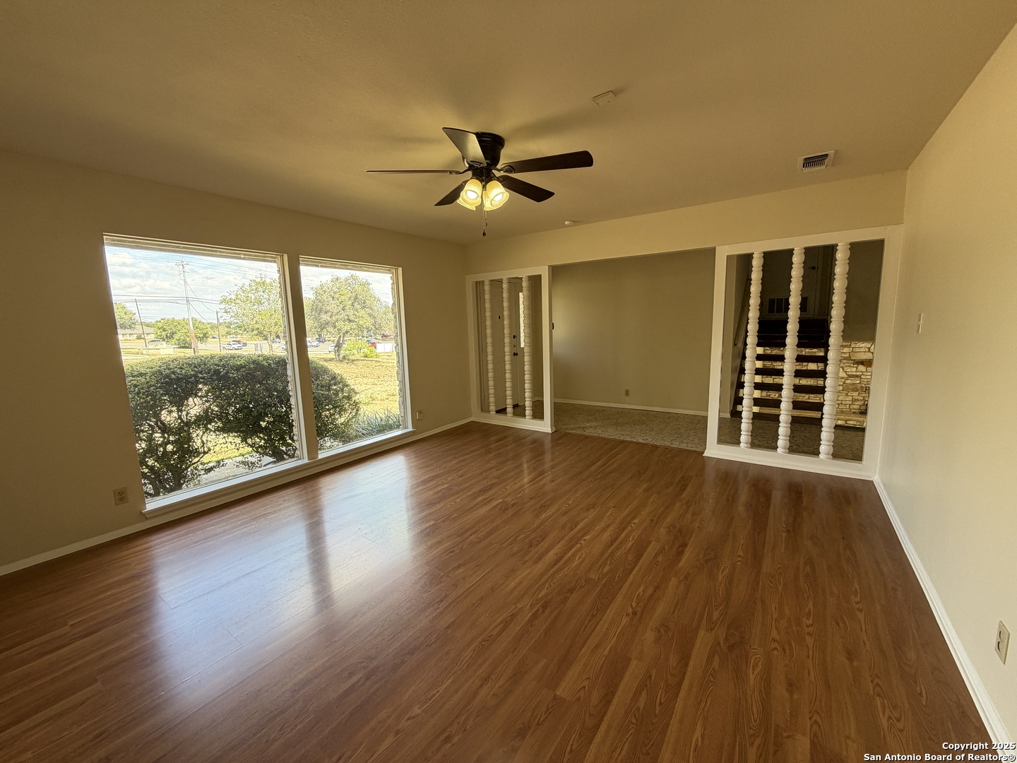 1236 East Live Oak Road Schertz, TX 78154 - Photo 8 of 20 a view of an empty room with wooden floor and a window