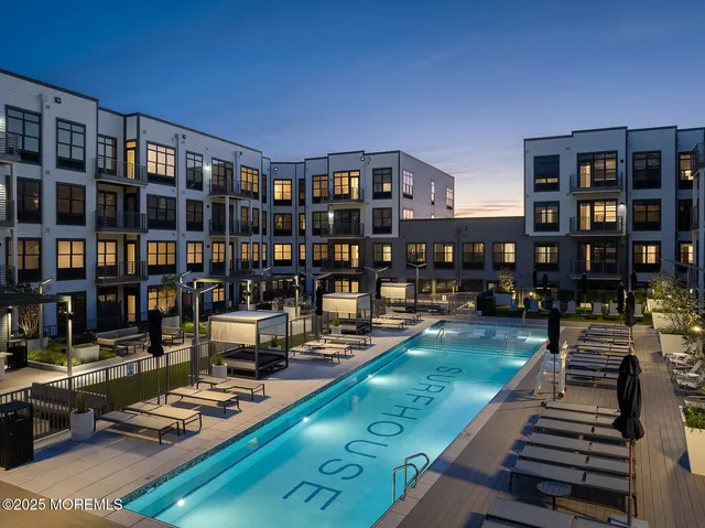 a living room with lots of furniture and a book shelf