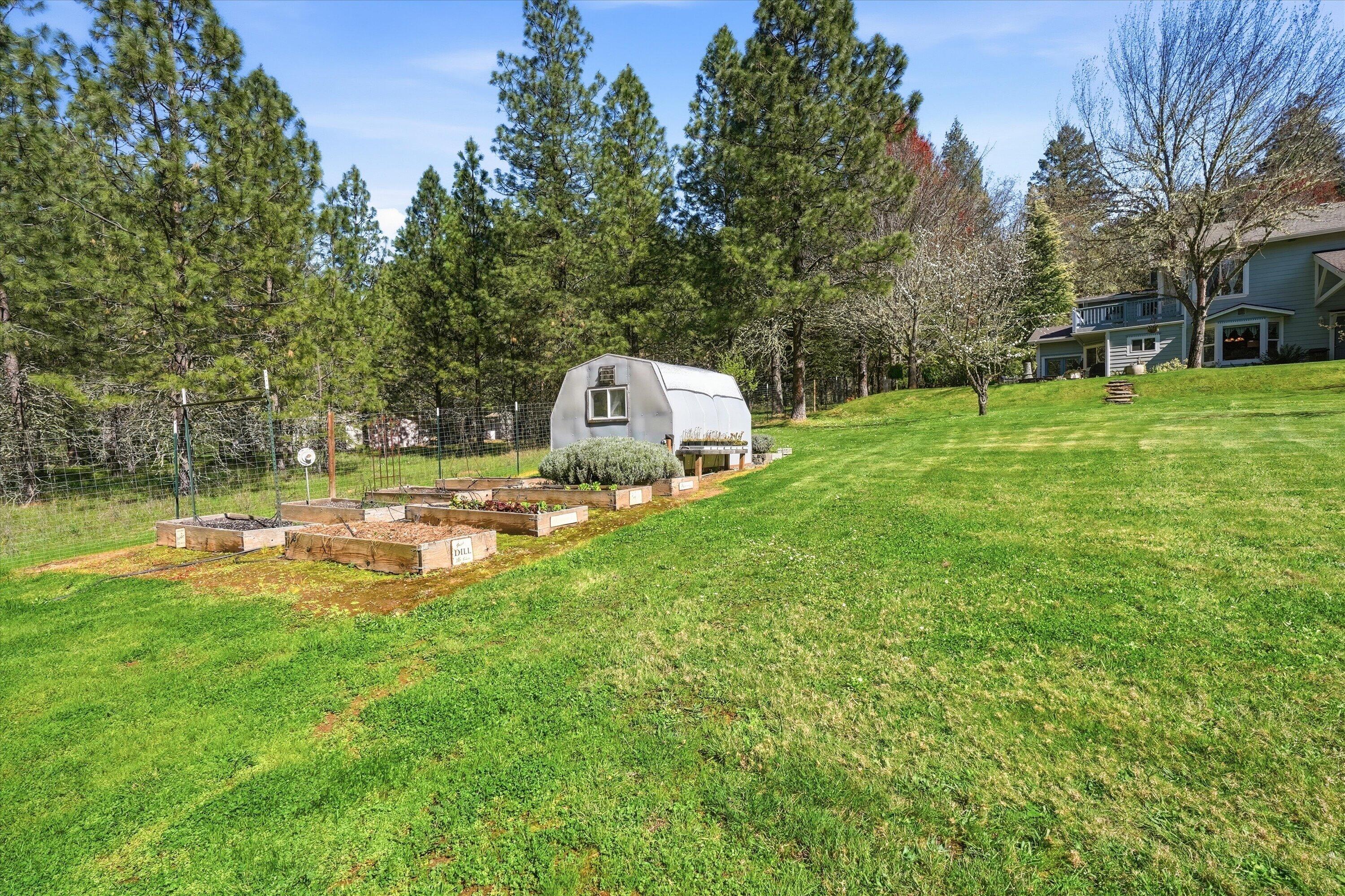 916 Ferry Road Grants Pass, OR 97526 - Photo 39 of 64 The grounds are immaculately maintained and include a greenhouse and raised beds.