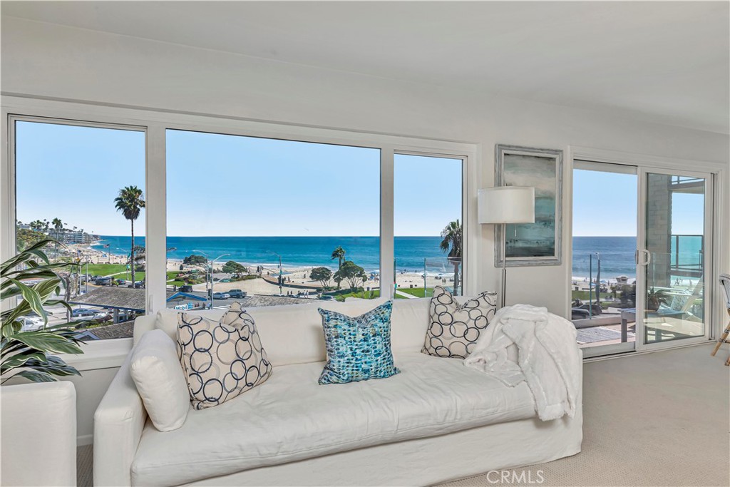 251 Lower Cliff Drive, Unit 8 Laguna Beach, CA 92651 - Photo 1 of 34 a living room with furniture and a floor to ceiling window