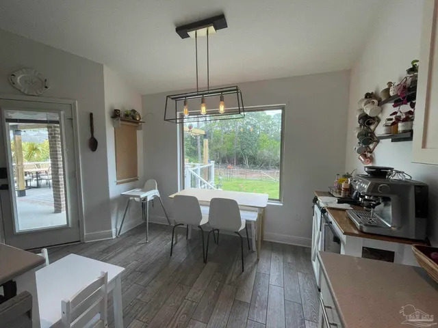 a view of a dining room with furniture window and outside view