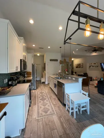 a kitchen with stainless steel appliances granite countertop a stove and a refrigerator