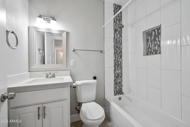 a bathroom with a sink toilet a mirror and shower