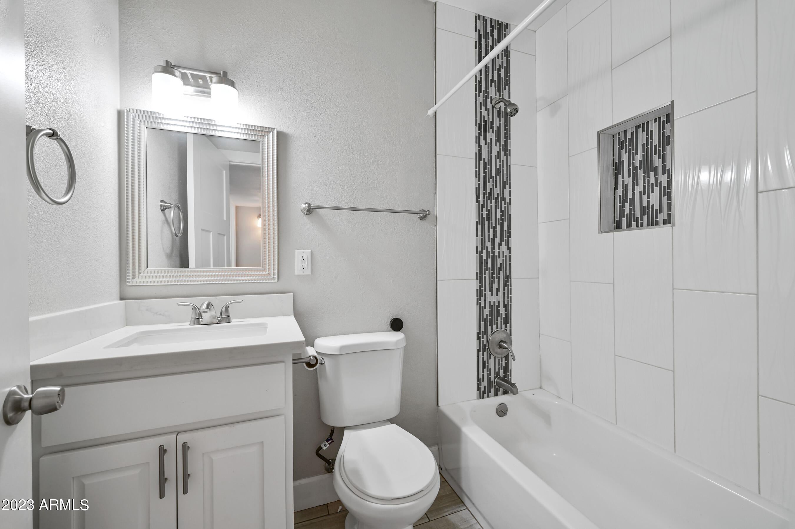 1145 East Henry Street Tempe, AZ 85288 - Photo 12 of 15 a bathroom with a sink toilet a mirror and shower