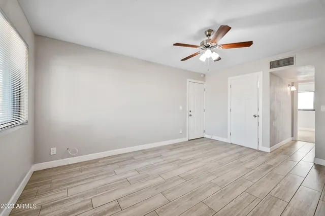 a view of empty room with wooden floor
