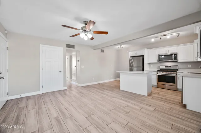 a view of kitchen with microwave and wooden floor