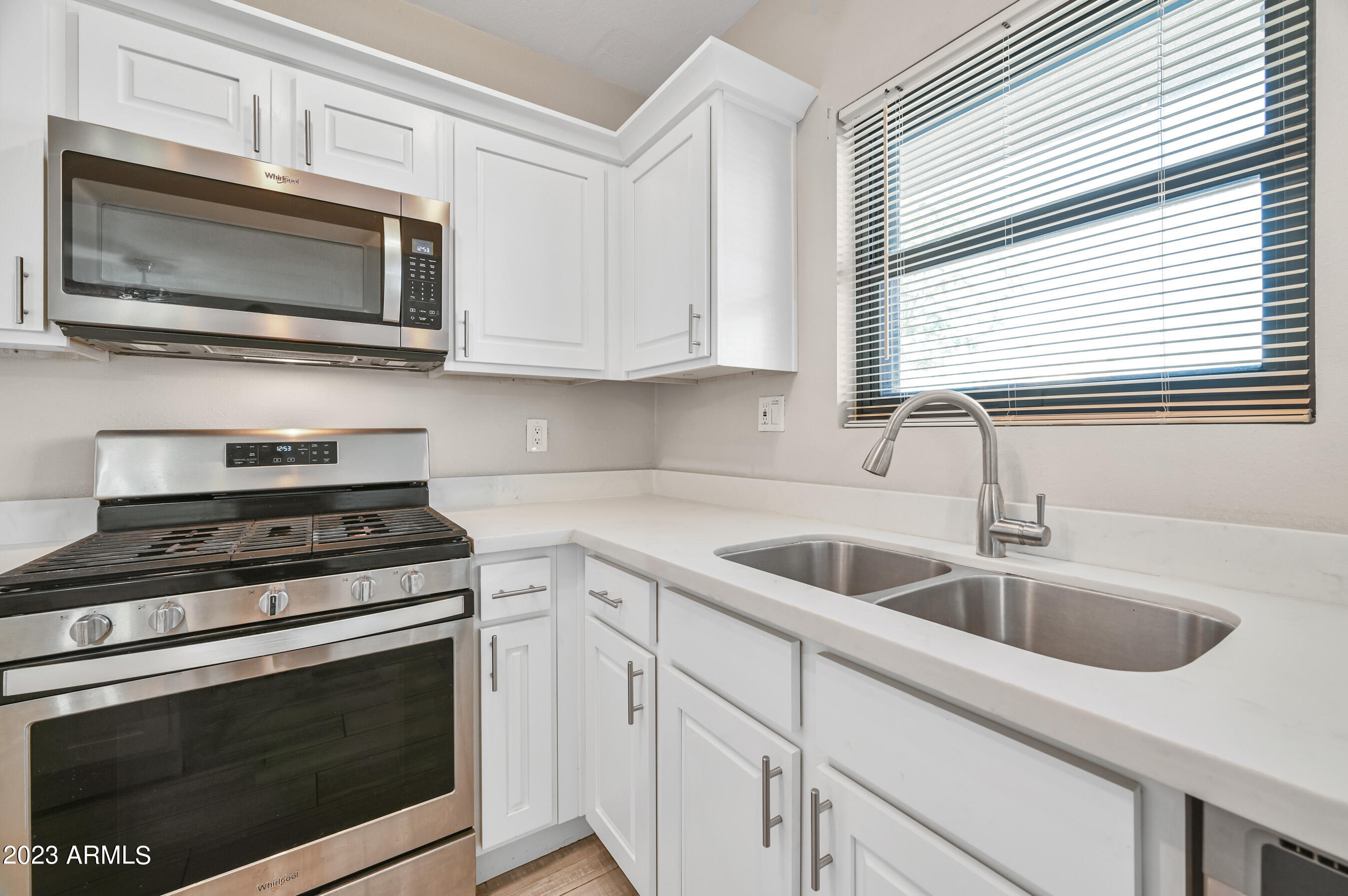 1145 East Henry Street Tempe, AZ 85288 - Photo 6 of 15 a kitchen with white cabinets appliances and a sink