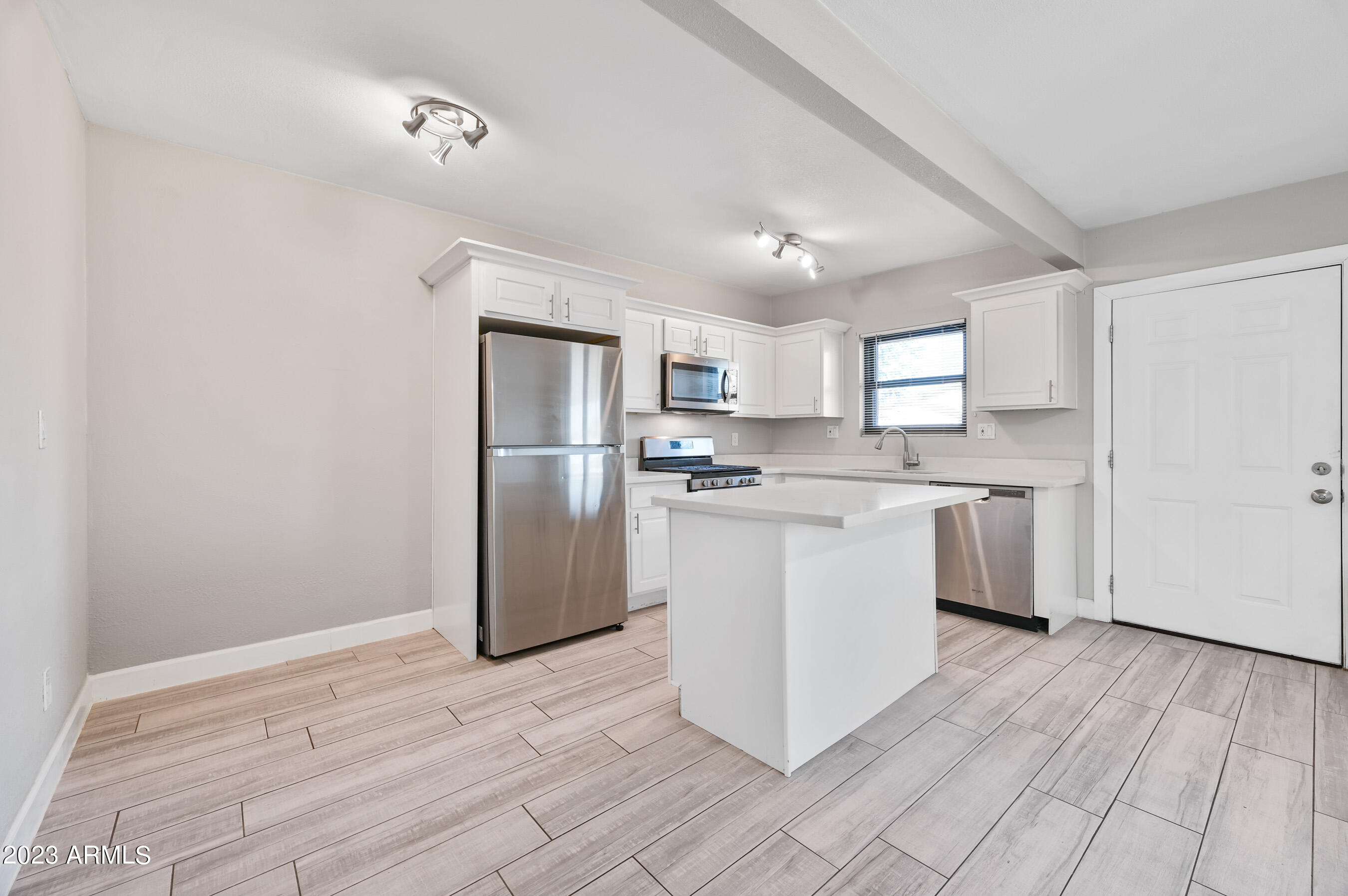 1145 East Henry Street Tempe, AZ 85288 - Photo 7 of 15 a kitchen with a refrigerator a sink dishwasher with a oven and cabinets with wooden floor