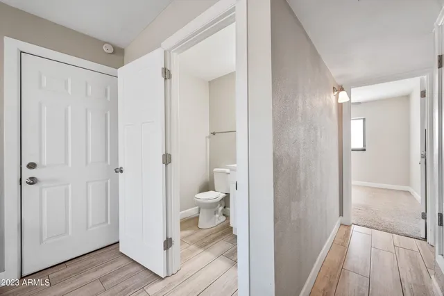 a view of a bathroom from a hallway with toilet