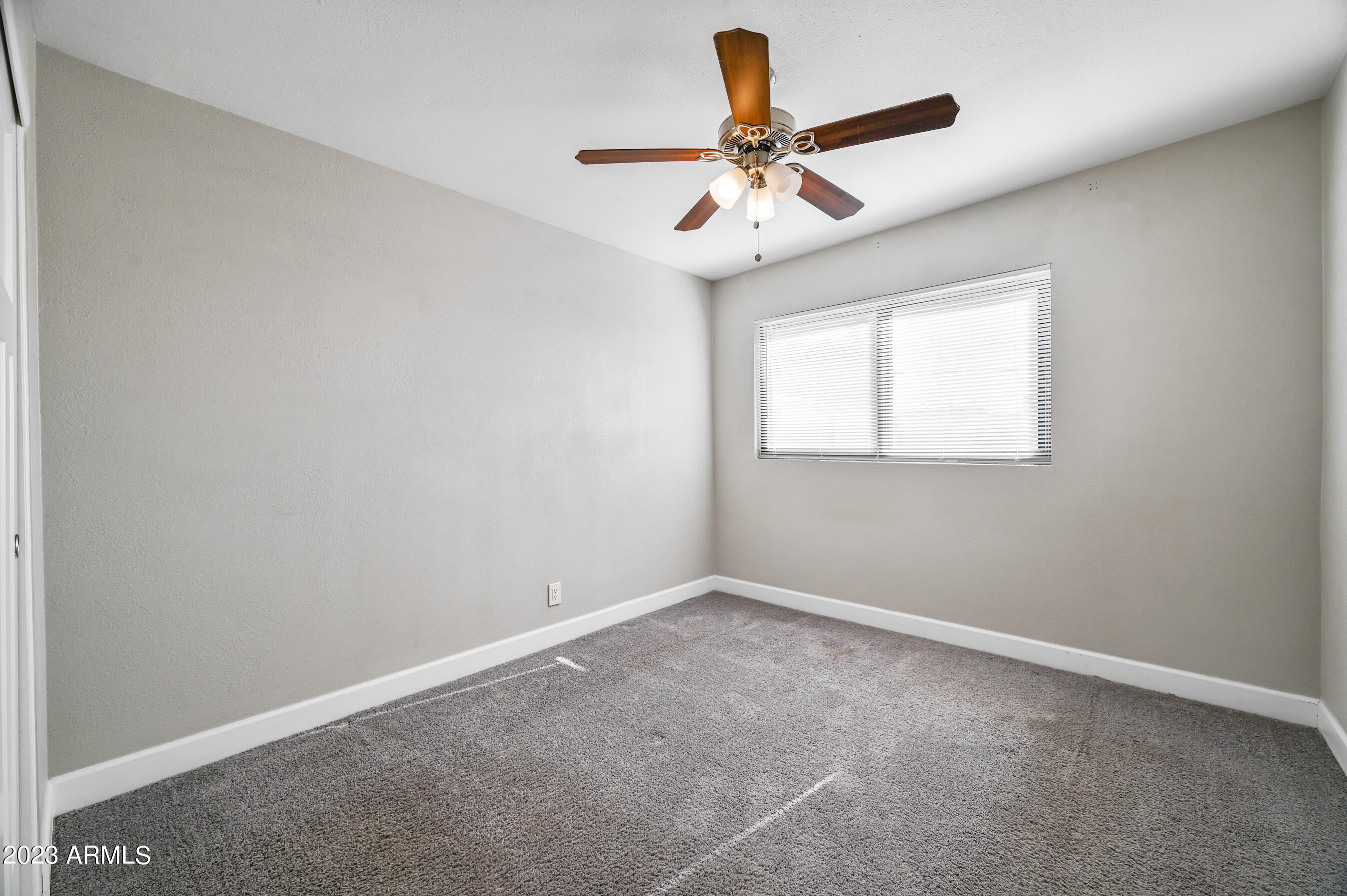 1145 East Henry Street Tempe, AZ 85288 - Photo 10 of 15 an empty room with a window and a ceiling fan