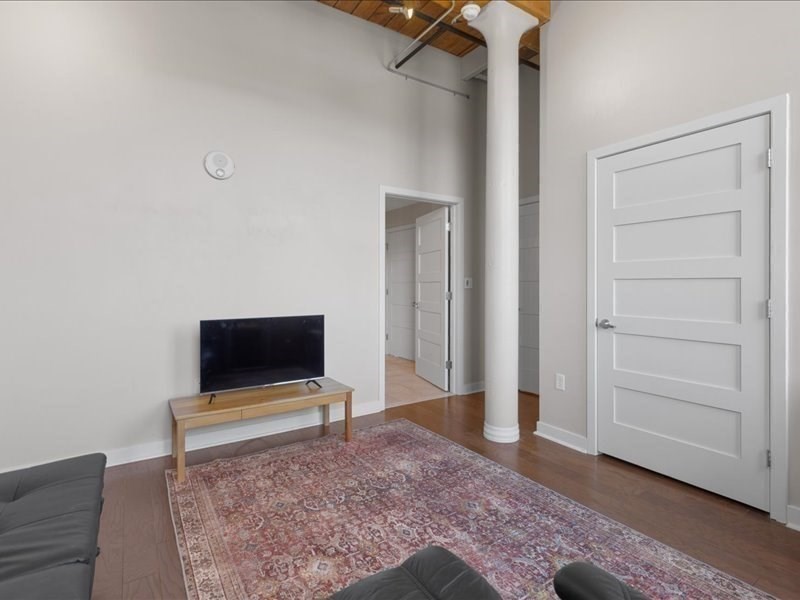 1245 Adams Street, Unit B210 Boston, MA 02124 - Photo 25 of 39 a living room with a flat screen tv and a rug