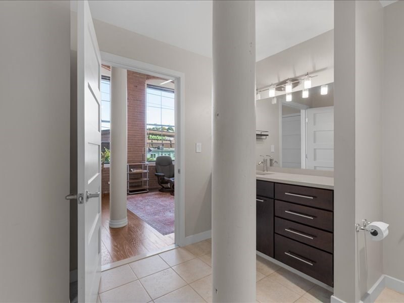 1245 Adams Street, Unit B210 Boston, MA 02124 - Photo 26 of 39 a bathroom with a mirror and a shower