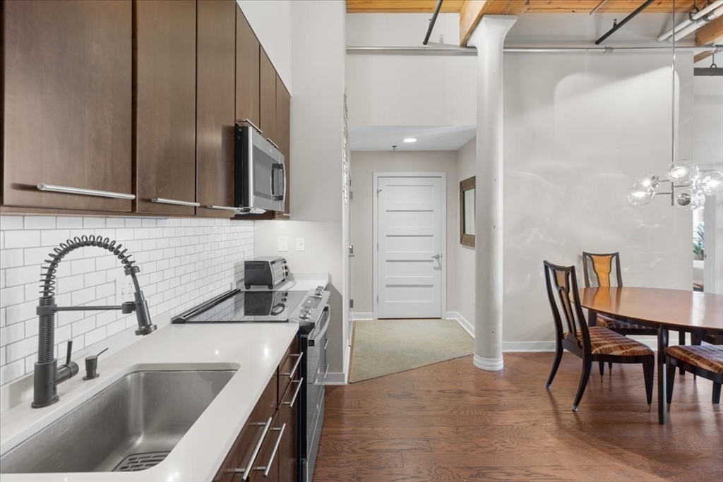 1245 Adams Street, Unit B210 Boston, MA 02124 - Photo 5 of 39 a kitchen with a sink cabinets and appliances