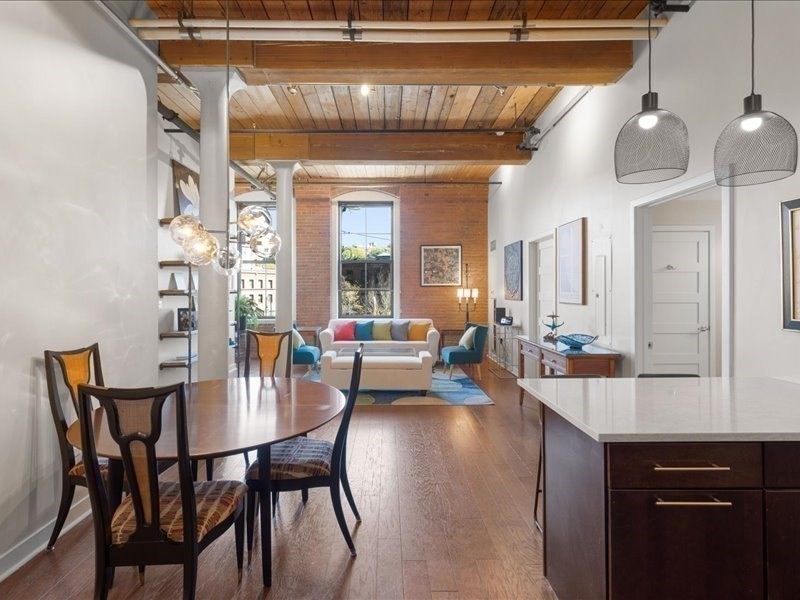 1245 Adams Street, Unit B210 Boston, MA 02124 - Photo 7 of 39 a view of a dining room with furniture and wooden floor