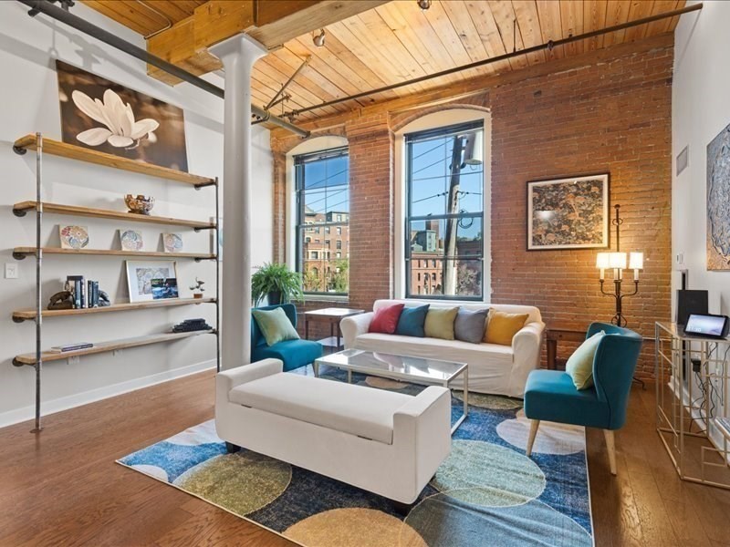 1245 Adams Street, Unit B210 Boston, MA 02124 - Photo 9 of 39 a living room with furniture and a rug