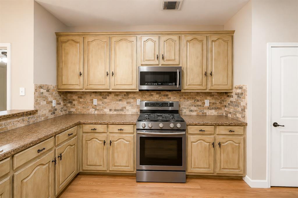 1070 Shepard Lane Lavon, TX 75166 - Photo 14 of 29 a kitchen with white cabinets and stainless steel appliances