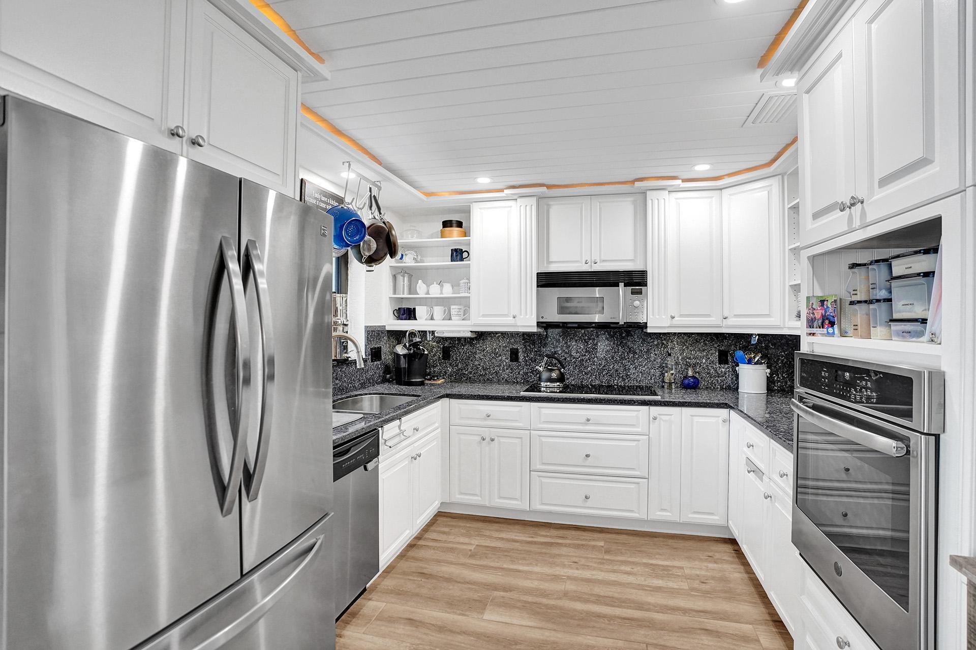 5612 Harding Street Hollywood, FL 33021 - Photo 13 of 59 a kitchen with stainless steel appliances a refrigerator sink and microwave