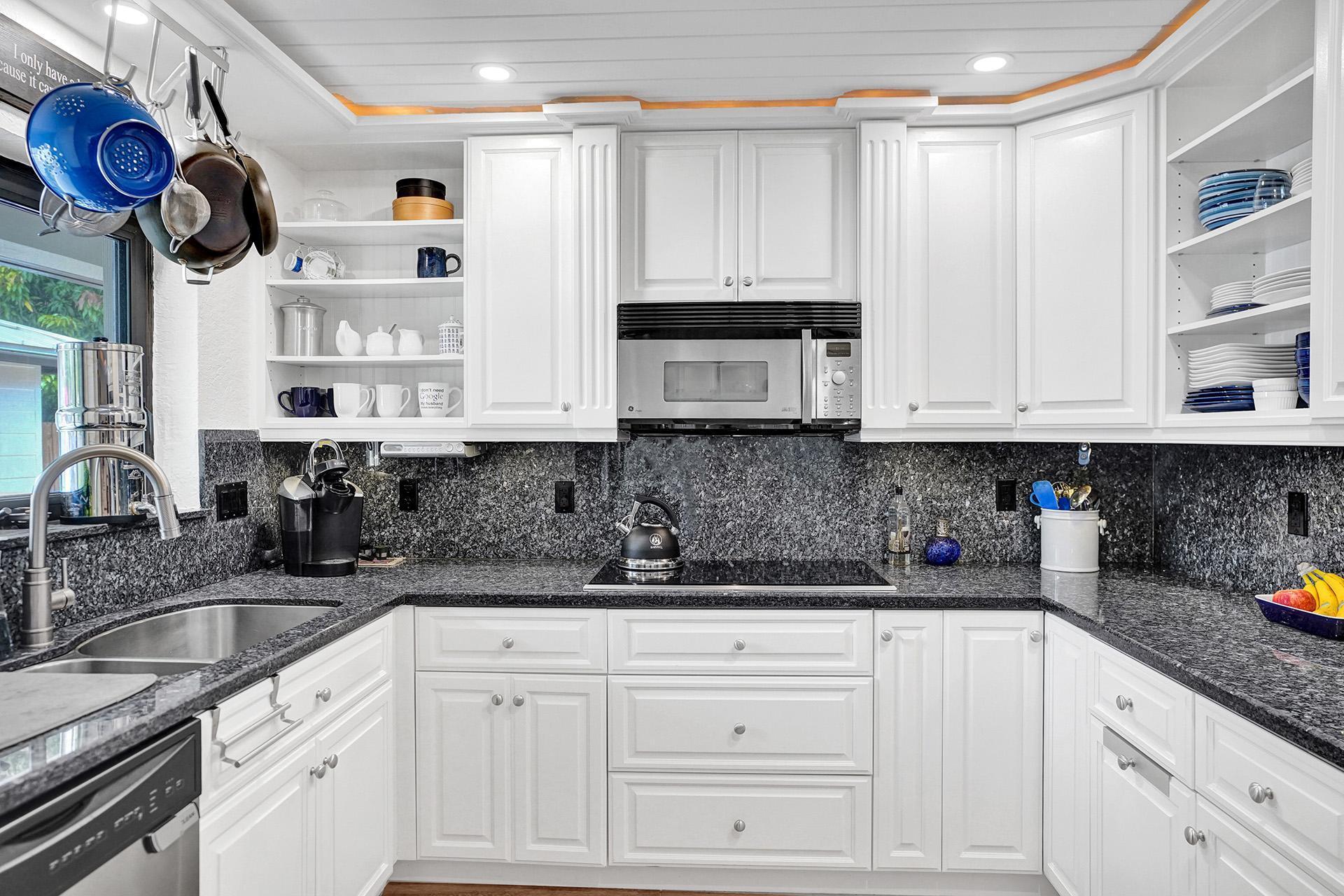 5612 Harding Street Hollywood, FL 33021 - Photo 14 of 59 a kitchen with stainless steel appliances granite countertop a sink a stove and cabinets
