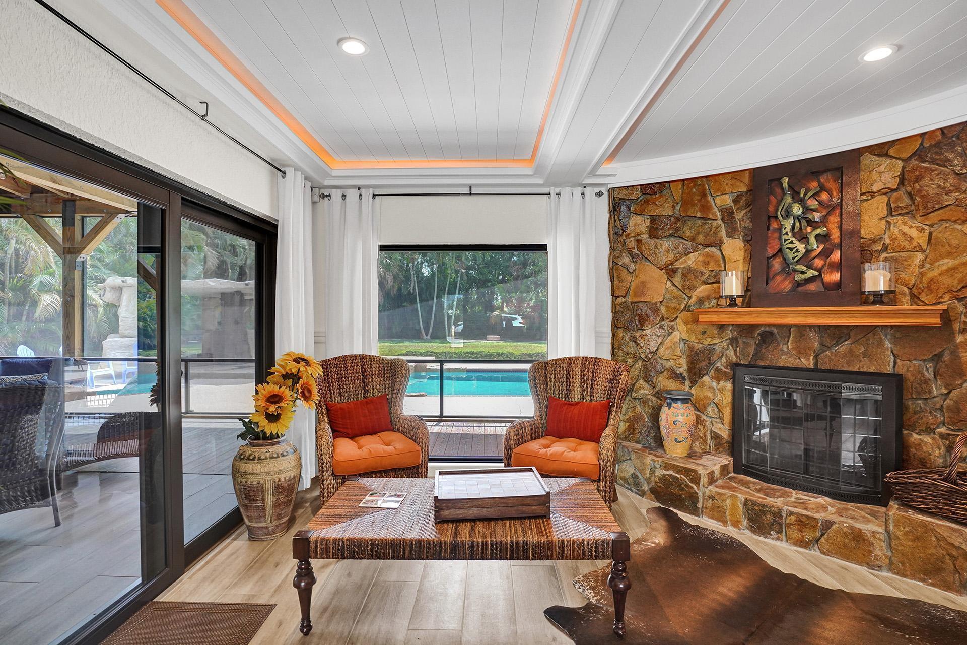 5612 Harding Street Hollywood, FL 33021 - Photo 19 of 59 a outdoor living space with furniture and a fireplace