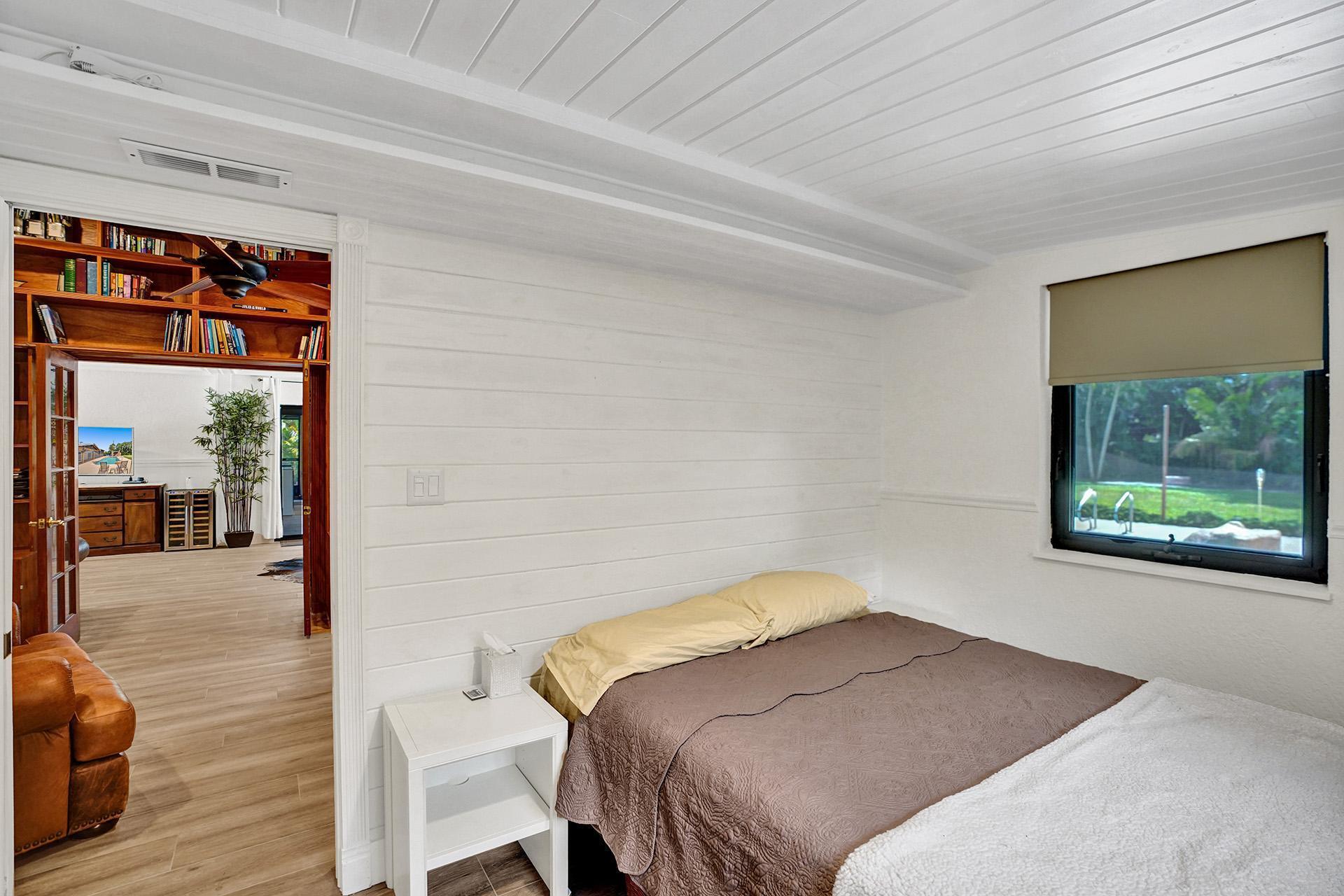 5612 Harding Street Hollywood, FL 33021 - Photo 24 of 59 a bedroom with a bed and a large window